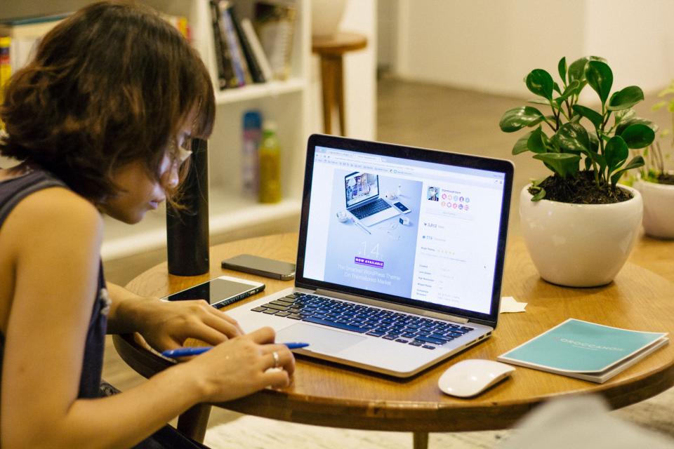 laptop apple macbook computer browser research study school business homework pen notebook writing interior plants flowerpot house interior people woman girl