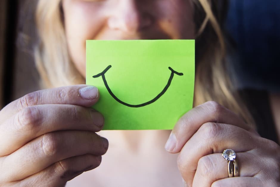 Photo of Woman Holding a Green Paper